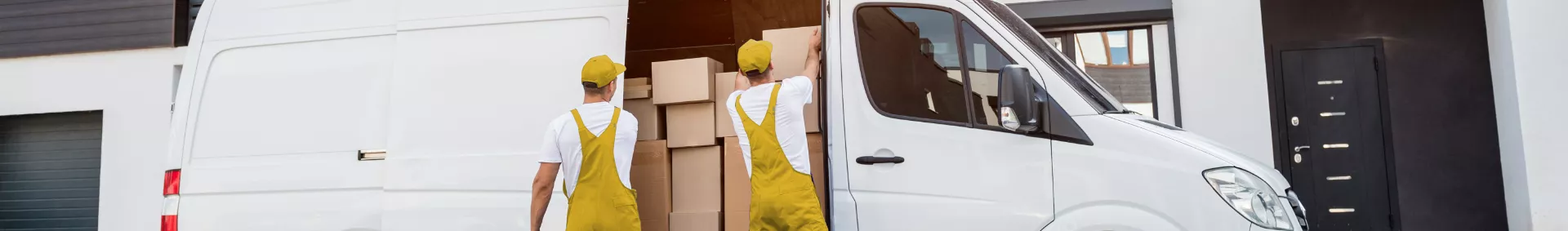 Movers packing boxes in a truck